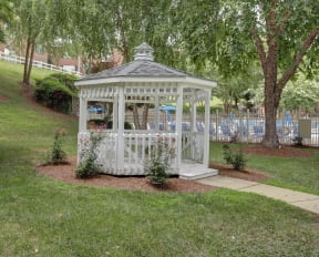 a white gazebo in the middle of a yard