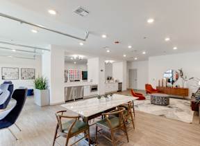 A modern dining room with a white table and chairs.