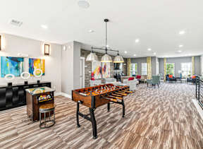 A room with a wooden floor and a pool table.