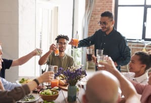 a group of people are sitting around a table with drinks at Chinoe Creek Apartments in Lexington KY