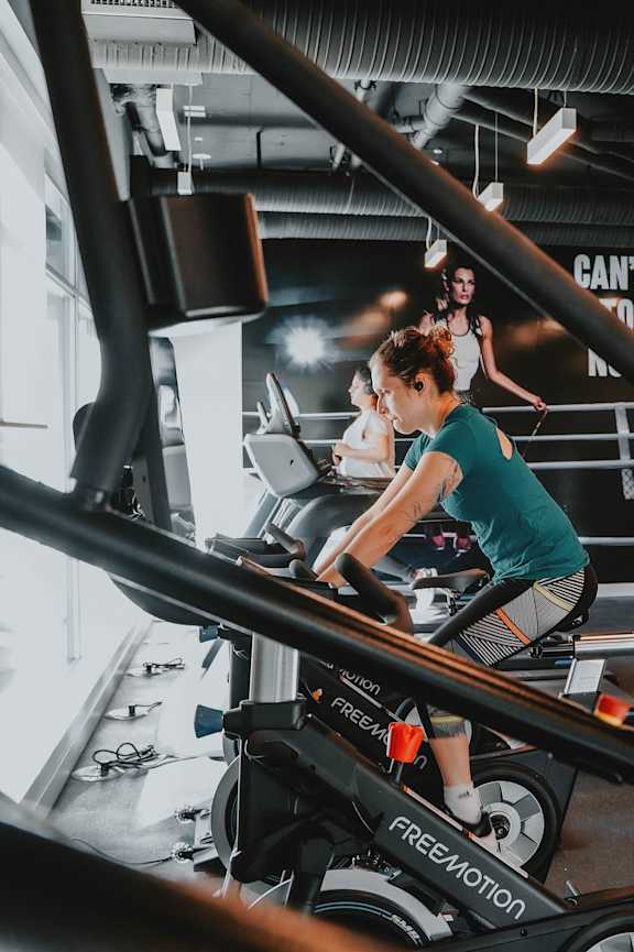 A person is working out on a stationary bike in a gym.