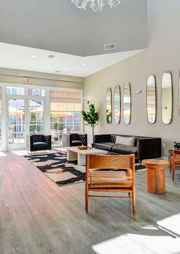 A living room with a white chair and wooden furniture.