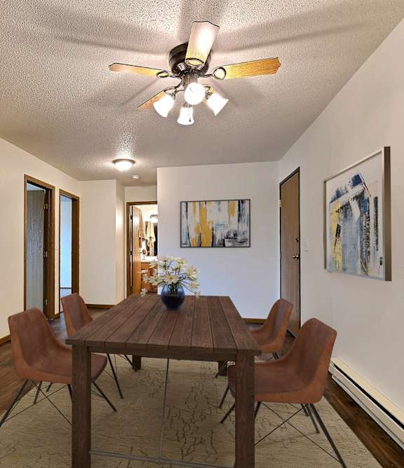 a dining room with a table and chairs and a ceiling fan