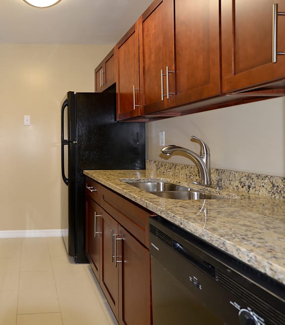 a kitchen with black appliances and granite counter tops
