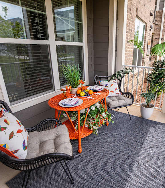 A patio with a table and chairs.