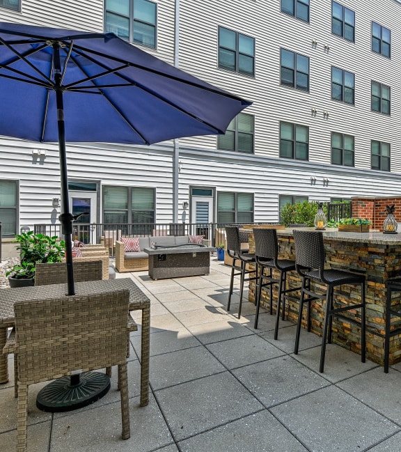 a patio with an umbrella and tables with chairs at The View at Old City, Philadelphia