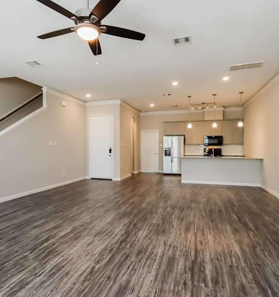 a kitchen with white cabinets and a stainless steel refrigerator