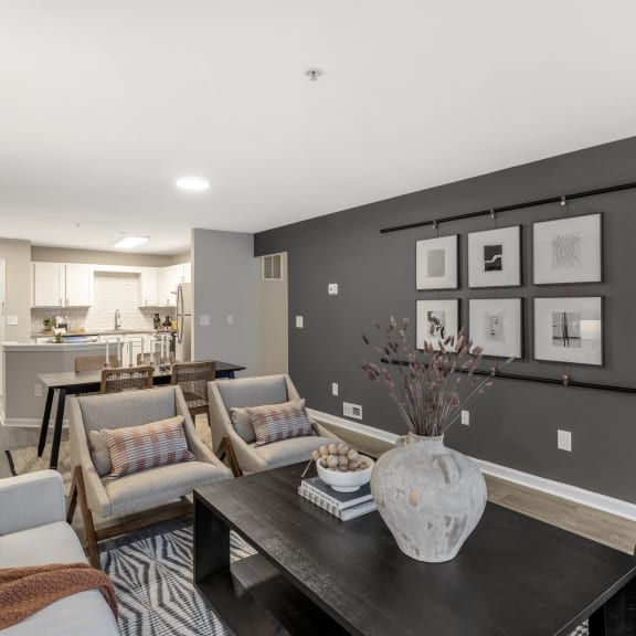 a living room with couches and a table with a vase at The Austin Apartment Homes, New Jersey