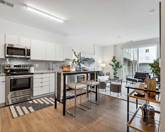 A modern kitchen with stainless steel appliances and white cabinets.
