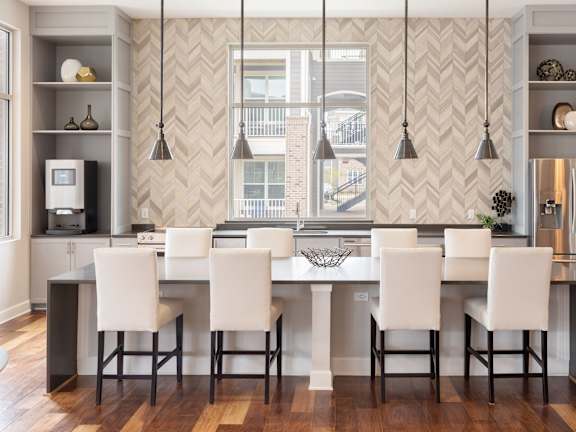 A kitchen with a table and chairs in front of a wallpapered wall.