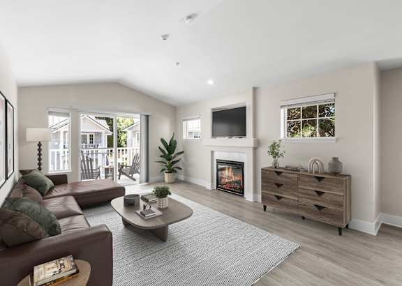 an empty living room with a ceiling fan
