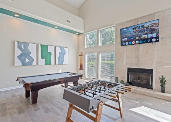 a games room with a foosball table and a fireplace