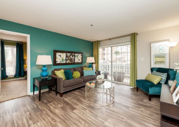 a living room with green walls and a sliding glass door