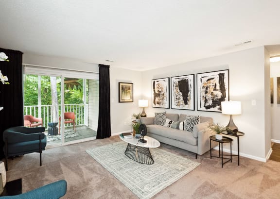 a living room with a couch and a chair and a sliding glass door