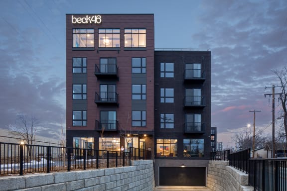 view of the building at dusk with the facade of the beekcbc building