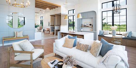 A modern living room with a white sofa and wooden furniture.