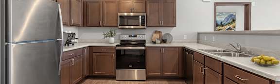 A modern kitchen with wooden cabinets and stainless steel appliances.