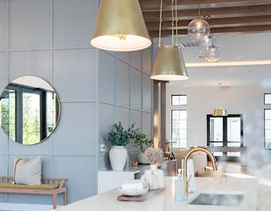 A modern kitchen with a large island and a bench.