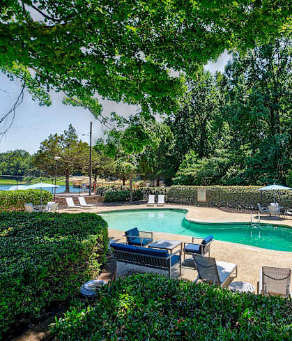 a pool with chairs and chairs around it and a swimming pool