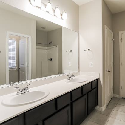 a bathroom with a large mirror and two sinks