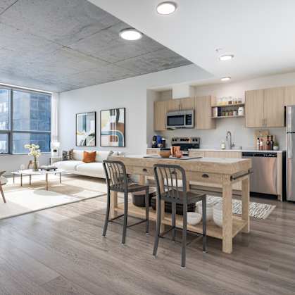A modern kitchen with a dining table and chairs.