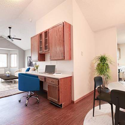 A room with a desk and a chair in it.