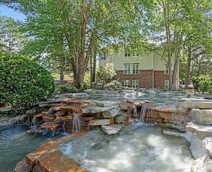 a backyard with a waterfall and rocks