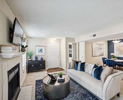 A living room with a fireplace and a couch.