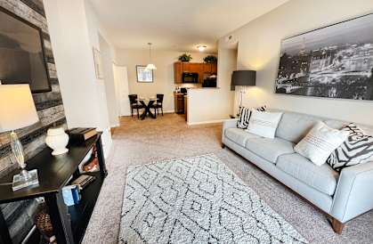 an open living room with a couch and a rug