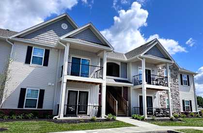 A two-story house with a balcony on the second floor.