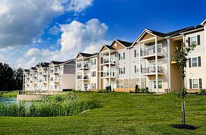 Apartment complex with a body of water in front.