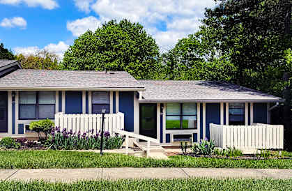 A blue house with a white picket fence.