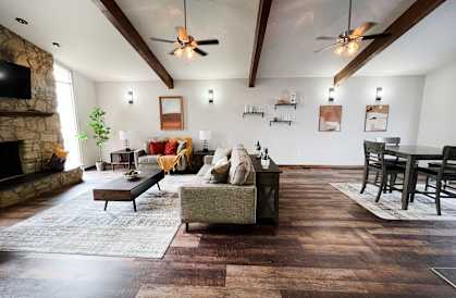 a living room with a couch and a table and a fireplace at Crown Ridge Apartments, Franklin, 45005