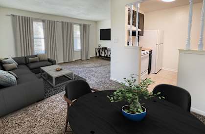 a living room with a table and a couch and a kitchenat Revere Village Apartments, Centerville, OH, 45458