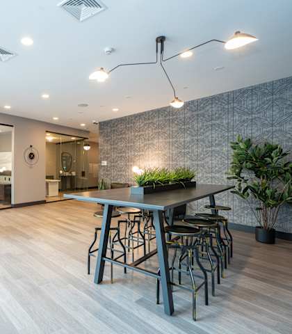 a large room with a table and chairs in the middle of it