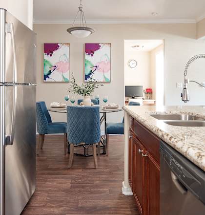a kitchen and dining room with stainless steel appliances and granite counter tops