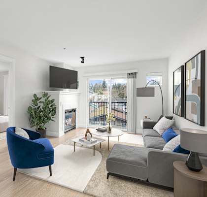 a bedroom with a bed and a living room with a couch and a chair