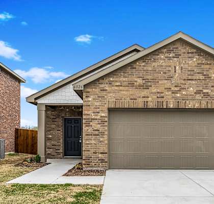 a brown brick house with a garage door