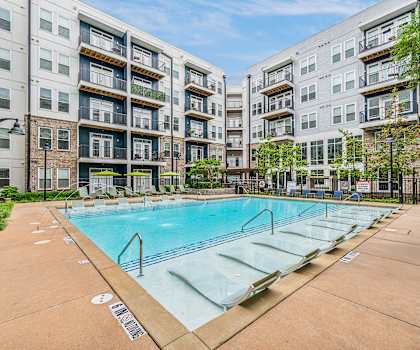 an apartment swimming pool in front of an apartment building at Glenwood at Grant Park, Georgia, 30316