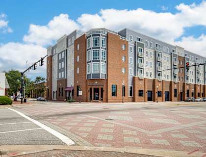 a large building on the corner of an empty street at The Constellation Apartments, PRG Real Estate, Virginia