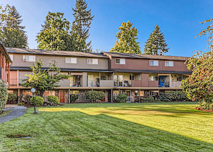 A building with a green lawn in front of it.