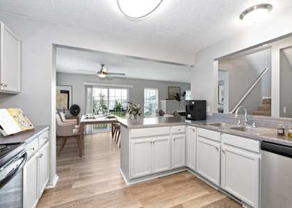 Summit Townhomes in Burnsville, MN photo of the view of a kitchen and living room with a large mirror