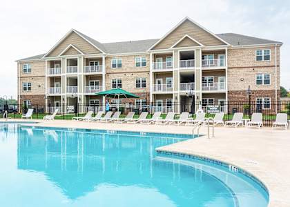 A large building with a pool in front.