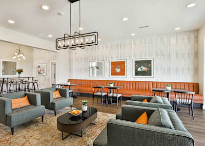 a living room with couches and chairs and a dining room with tables