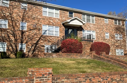 a brick apartment building with a staircase and a front yard at Park Place, Richmond, KY, 40475