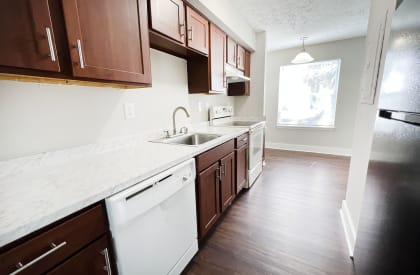a kitchen with white countertops and dark wood cabinets at 450 on Keeneland, Richmond, KY 40475