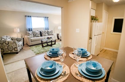 a dining room and living room with blue plates on a table at Oakwood Apartments, Florence, KY, 41042