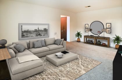 a living room with a gray couch and a coffee table  at Four Worlds Apartments, Cincinnati, OH