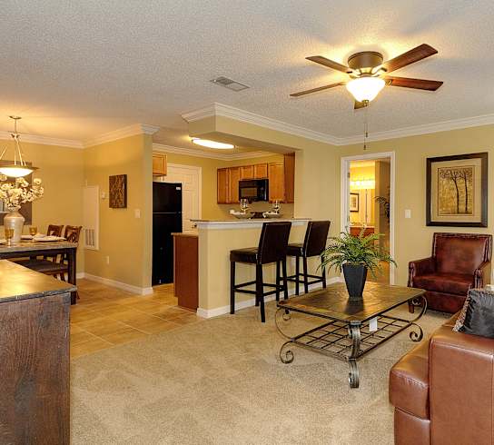 a living room and kitchen with a ceiling fan