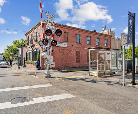 A red brick building with a sign that says  at The Merc, Waltham, MA, 02453